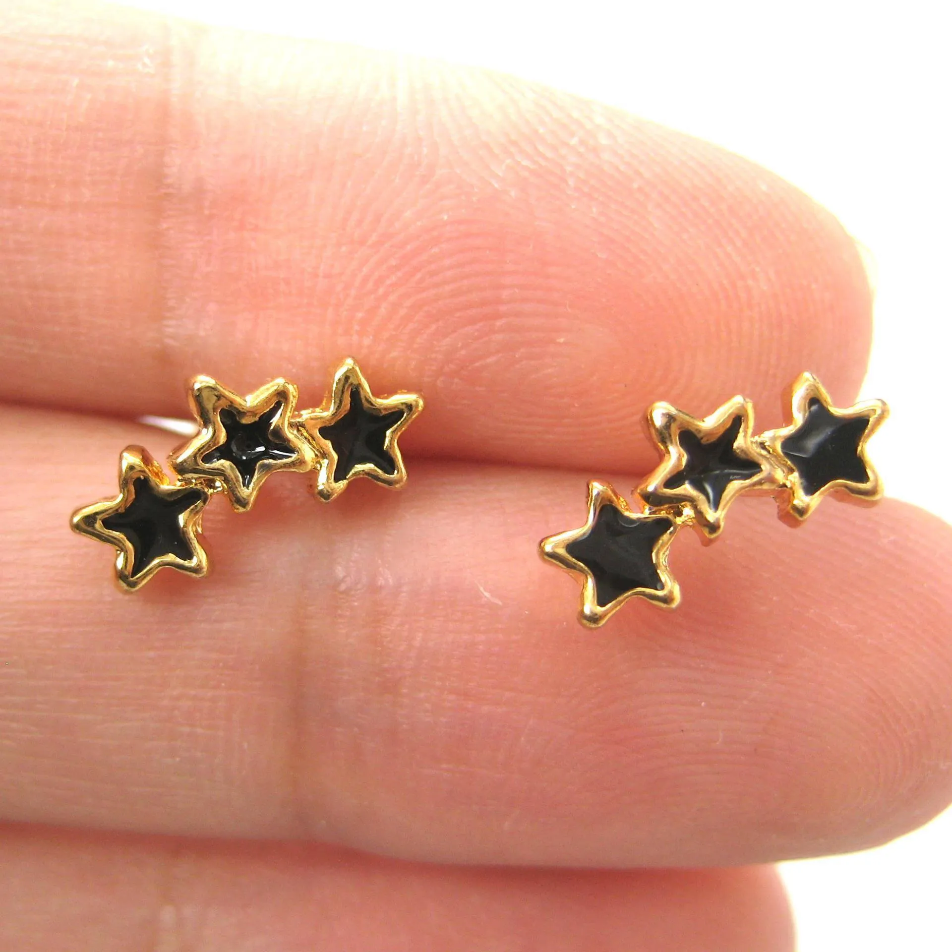 Small Connected Star Shaped Stud Earrings in Black on Gold